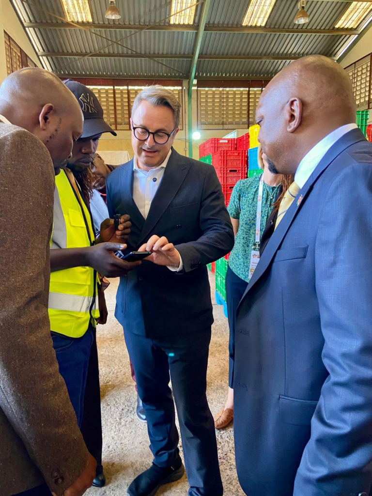H.E. Xavier Bettel looks at the Taimba Limited digital B2B platform, on a mobile phone