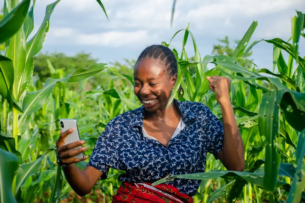A young famer celebrates her new phone