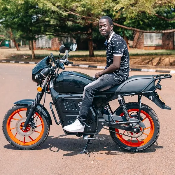 Man who got a boda boda loan from Fortune Credit sitting on his motorbike