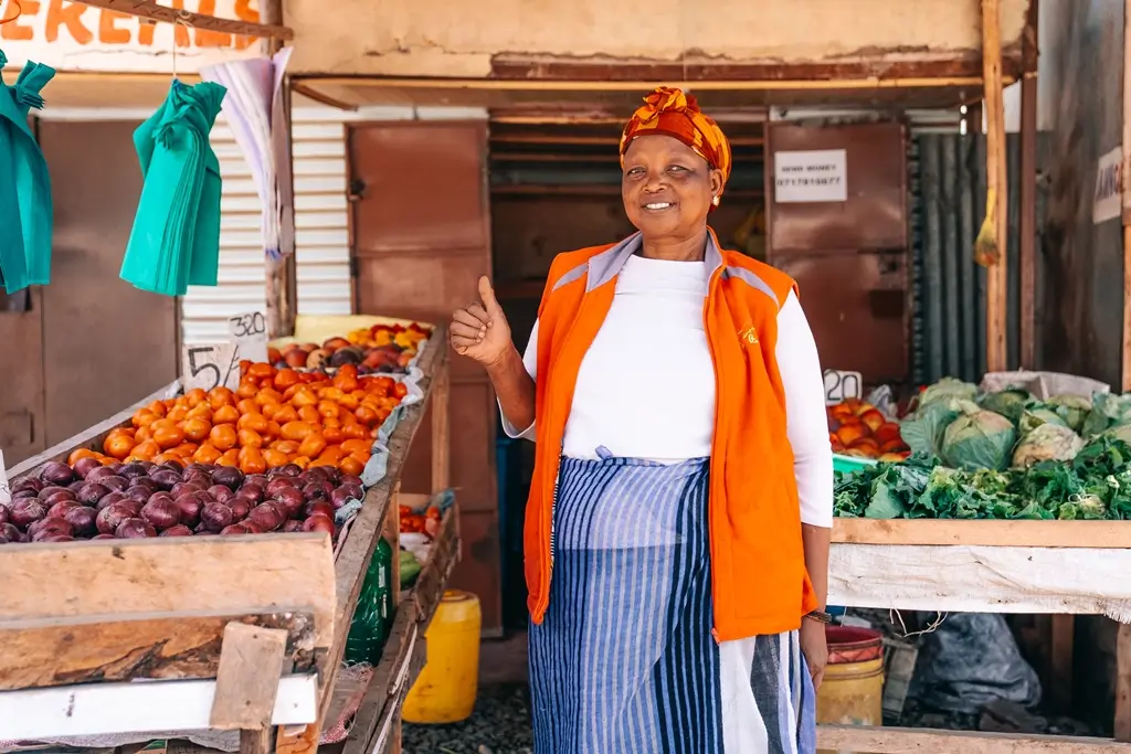 Vegetable vendor at market stall in Kenya