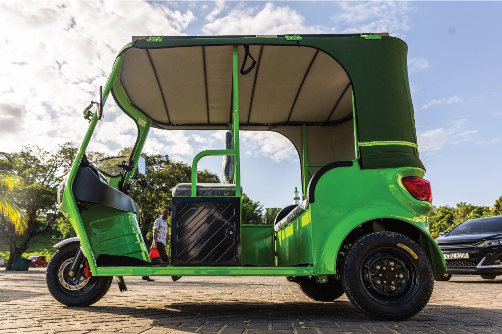 A green electric tuk-tuk financed through Fortune Credit Tuk-Tuk Loan
