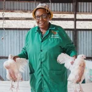 Grace Njeri with chickens she has raised