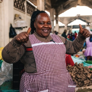 Jane Muiruri with a basket of ginger roots